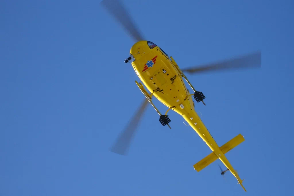 A yellow rescue helicopter in the sky