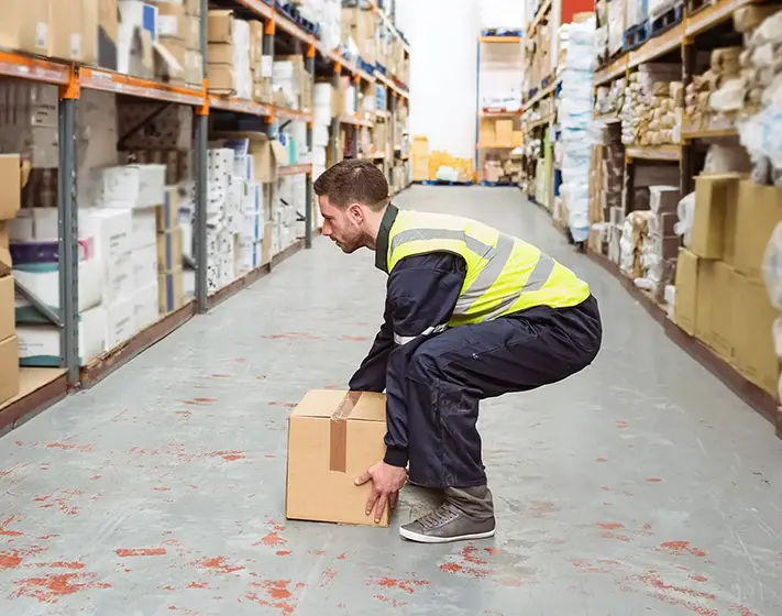 Workplace training man lifting box